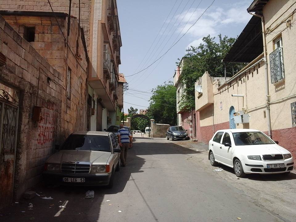 A street with cars parked on the side.